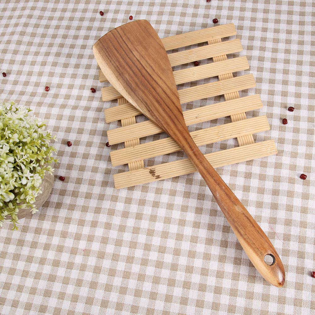 Broad-blade kitchen turner resting on a slatted display mat over checked cloth